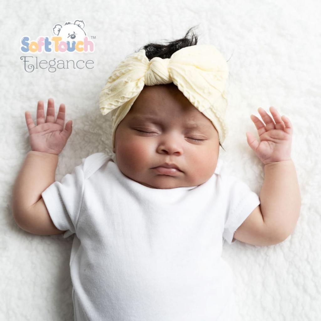 Kojenecká bílá čelenka s velkou vzorovanou mašlí